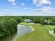 Aerial view of the waterfront restaurant and golf course, surrounded by trees and a small pond at 69 Pinehurst Ln. # 3-F, Pawleys Island, SC 29585