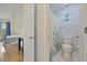 Second bathroom featuring a toilet, tile floors, and a charming palm tree shower curtain at 69 Pinehurst Ln. # 3-F, Pawleys Island, SC 29585