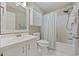 Clean bathroom with white fixtures, a cabinet above the toilet, and a shower-tub combination at 69 Pinehurst Ln. # 3-F, Pawleys Island, SC 29585