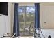Serene bedroom with a rocking chair on the balcony, beautiful green views, and natural light at 69 Pinehurst Ln. # 3-F, Pawleys Island, SC 29585