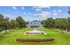 Attractive blue roofed clubhouse overlooks manicured lawn with fountain and colorful flower bed at 69 Pinehurst Ln. # 3-F, Pawleys Island, SC 29585