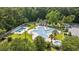 Aerial view of a community pool, cabana, hot tub, lush landscaping, and white fencing at 69 Pinehurst Ln. # 3-F, Pawleys Island, SC 29585