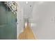 Inviting entryway with a coat closet, light hardwood floors and white walls leading to the living area at 69 Pinehurst Ln. # 3-F, Pawleys Island, SC 29585