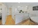 Efficient kitchen with white cabinets, an eat-in counter, hardwood flooring, and natural light at 69 Pinehurst Ln. # 3-F, Pawleys Island, SC 29585