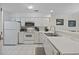 Bright kitchen with white cabinetry, appliances, tile flooring, and stainless steel faucet at 69 Pinehurst Ln. # 3-F, Pawleys Island, SC 29585