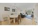 Cozy living area with hardwood flooring, a ceiling fan, dining table and exterior access at 69 Pinehurst Ln. # 3-F, Pawleys Island, SC 29585