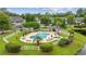 Community pool surrounded by green landscaping, palm trees, and residences at 69 Pinehurst Ln. # 3-F, Pawleys Island, SC 29585