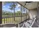 Cozy screened porch featuring a ceiling fan and scenic views of the surrounding landscape at 69 Pinehurst Ln. # 3-F, Pawleys Island, SC 29585