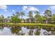 Condominiums near a pond reflecting the building and trees, with a serene water view at 69 Pinehurst Ln. # 3-F, Pawleys Island, SC 29585
