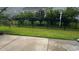 A manicured backyard with a black metal fence, lush trees, and a birdhouse, enhancing privacy and charm at 692 Cherry Blossom Dr., Murrells Inlet, SC 29576