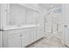 En-suite bathroom featuring double sinks, a glass-door shower, and neutral tile at 692 Cherry Blossom Dr., Murrells Inlet, SC 29576