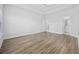 Empty bedroom with hardwood floors, a ceiling fan, and two doors for closets or en-suite bath at 692 Cherry Blossom Dr., Murrells Inlet, SC 29576