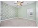 Well-lit bedroom with green accent wall and large window at 692 Cherry Blossom Dr., Murrells Inlet, SC 29576