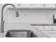 Close up of kitchen sink with granite countertops and white cabinets at 692 Cherry Blossom Dr., Murrells Inlet, SC 29576