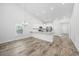 Kitchen and dining area with white cabinets, modern appliances and hardwood floors at 692 Cherry Blossom Dr., Murrells Inlet, SC 29576