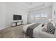 Modern primary bedroom with tray ceiling, fan, lots of light, and view of the water at 692 Cherry Blossom Dr., Murrells Inlet, SC 29576