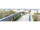 Beach access boardwalk and handrail with grassy dunes on both sides and beach in the background at 7100 N Ocean Blvd. N # 1011, Myrtle Beach, SC 29572