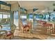 Restaurant interior with seating, a bar, and beach views through large glass doors at 7100 N Ocean Blvd. N # 1011, Myrtle Beach, SC 29572