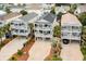 Aerial view of raised beach houses with covered balconies offering stunning neighborhood views and outdoor living spaces at 712A Ocean Blvd. S, Surfside Beach, SC 29575