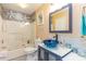 Coastal bathroom featuring a glass bowl sink, stylish vanity, and a shower-tub combination at 712A Ocean Blvd. S, Surfside Beach, SC 29575