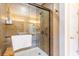 Modern glass-enclosed shower with decorative tile work, with a bench and towel bar at 712A Ocean Blvd. S, Surfside Beach, SC 29575