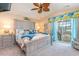 Nautical themed primary bedroom with a king-sized bed and sliding glass doors leading to a private balcony at 712A Ocean Blvd. S, Surfside Beach, SC 29575