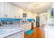 Modern kitchen with granite countertops, custom cabinets, and stainless steel appliances at 712A Ocean Blvd. S, Surfside Beach, SC 29575