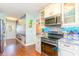 Stylish kitchen with tile backsplash, modern appliances, and an adjacent dining area at 712A Ocean Blvd. S, Surfside Beach, SC 29575