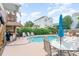 An inviting pool with lounge chairs and an umbrella offers a perfect spot to relax and enjoy the outdoor lifestyle at 712A Ocean Blvd. S, Surfside Beach, SC 29575