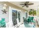 Relaxing porch featuring ceiling fans, rocking chairs, and views of the surrounding neighborhood at 712A Ocean Blvd. S, Surfside Beach, SC 29575