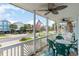 Charming porch with ceiling fans and comfortable seating for relaxing with neighborhood views at 712A Ocean Blvd. S, Surfside Beach, SC 29575