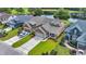 An aerial view of the property showcases the well-manicured lawn and its proximity to a pond and golf course at 7317 Lieth Ln., Sunset Beach, NC 28468