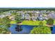 Aerial view of lakeside homes highlighting the picturesque neighborhood and the community pond at 7317 Lieth Ln., Sunset Beach, NC 28468