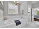 Luxurious soaking tub with marble tile surround and a view to the glass enclosed shower at 7317 Lieth Ln., Sunset Beach, NC 28468