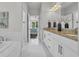 Bathroom with granite countertops, double sinks, white cabinets, and a view into the bedroom at 7317 Lieth Ln., Sunset Beach, NC 28468