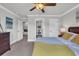 Bedroom featuring neutral walls and carpet, ceiling fan and doors leading to bathroom and hallway at 7317 Lieth Ln., Sunset Beach, NC 28468