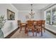 Elegant dining room with wood table, decorative chairs, light fixture, and artwork at 7317 Lieth Ln., Sunset Beach, NC 28468