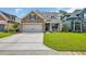 Charming two-story home featuring a manicured lawn and a welcoming front porch with seating at 7317 Lieth Ln., Sunset Beach, NC 28468