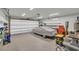 A spacious garage featuring ample storage shelves, organized tools, and a covered car at 7317 Lieth Ln., Sunset Beach, NC 28468
