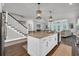Kitchen island with granite counters, stainless appliances, and an open view to the living area at 7317 Lieth Ln., Sunset Beach, NC 28468