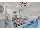 Upstairs bonus room featuring a sectional couch, television, and a ceiling fan at 7317 Lieth Ln., Sunset Beach, NC 28468