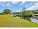 Scenic view of a tranquil pond surrounded by lush greenery, reflecting a clear blue sky at 7317 Lieth Ln., Sunset Beach, NC 28468