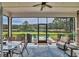 Screened-in porch featuring a beautiful lake view, ceiling fan, and outdoor seating and dining space at 7317 Lieth Ln., Sunset Beach, NC 28468