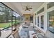 Screened-in porch boasting an outdoor stone fireplace, comfortable seating, and views of the golf course at 7317 Lieth Ln., Sunset Beach, NC 28468