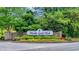 Entrance to Thistle Golf Club featuring a stone sign and well-maintained landscaping at 7317 Lieth Ln., Sunset Beach, NC 28468