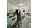 Galley style kitchen features appliances, light cabinets and tiled floor at 755 Burcale Rd. # G4, Myrtle Beach, SC 29579