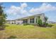 A well-maintained backyard featuring a grassy lawn, screened porch, and outdoor seating area at 779 Salerno Circle # A, Myrtle Beach, SC 29579