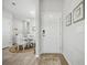 Inviting entryway featuring a white door, neutral walls, and wood-look flooring leading to a dining area at 779 Salerno Circle # A, Myrtle Beach, SC 29579
