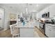 Bright, open kitchen featuring white cabinets, stainless steel appliances, and a large island with bar seating at 779 Salerno Circle # A, Myrtle Beach, SC 29579