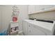Bright laundry room with white cabinets, shelving, and modern appliances at 779 Salerno Circle # A, Myrtle Beach, SC 29579